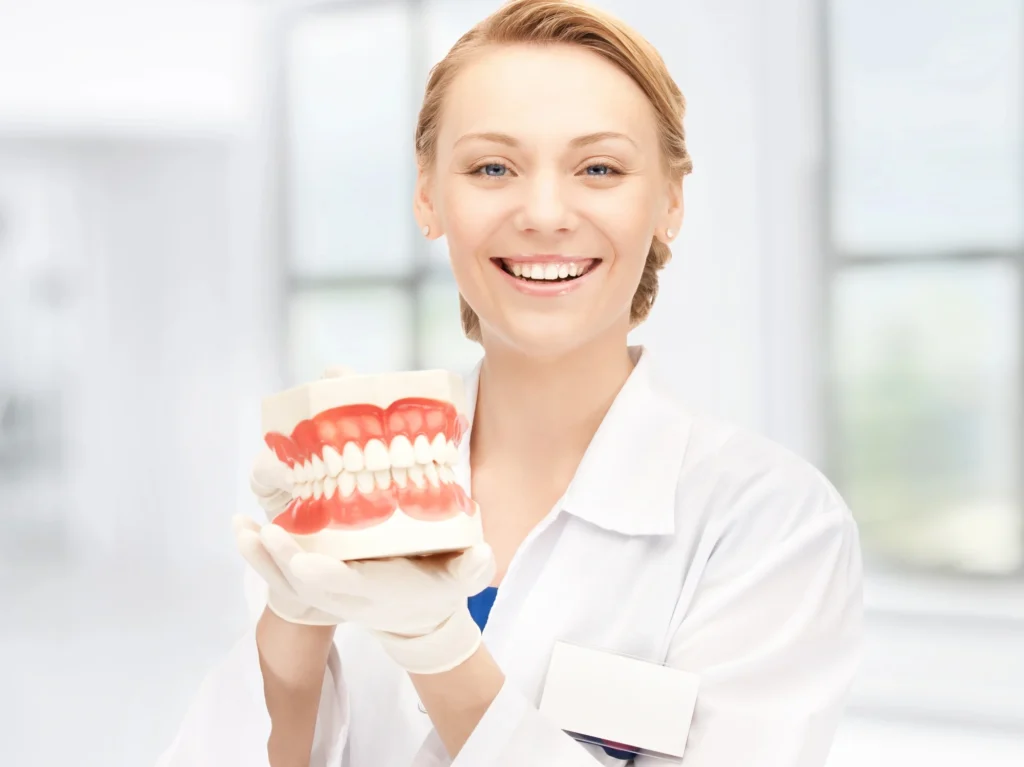 dentist holding dentures in waxhaw